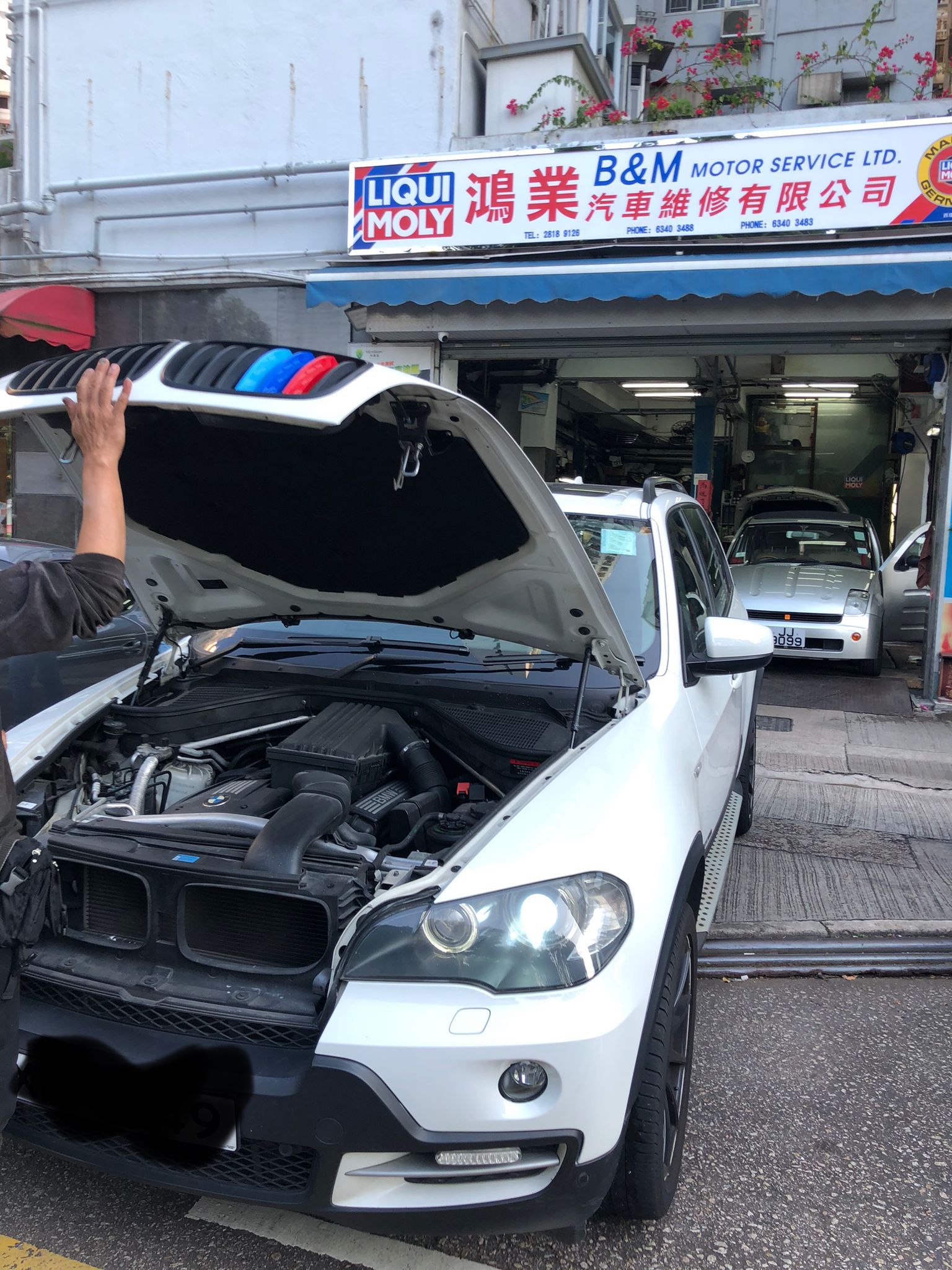 BMW engine bay with technician